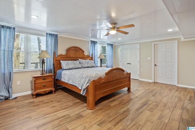 bedroom with baseboards, multiple windows, and light wood-style flooring