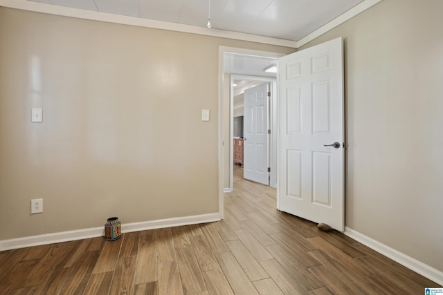 unfurnished room featuring baseboards and wood finished floors