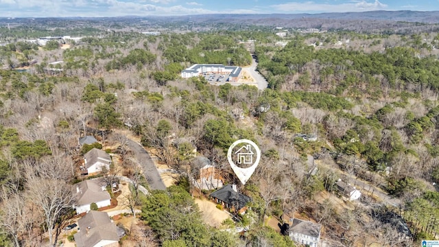 drone / aerial view featuring a wooded view