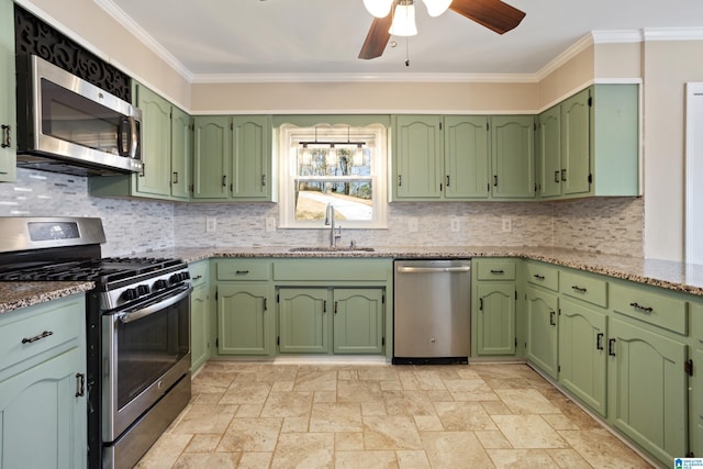 kitchen featuring ornamental molding, a sink, tasteful backsplash, stainless steel appliances, and ceiling fan