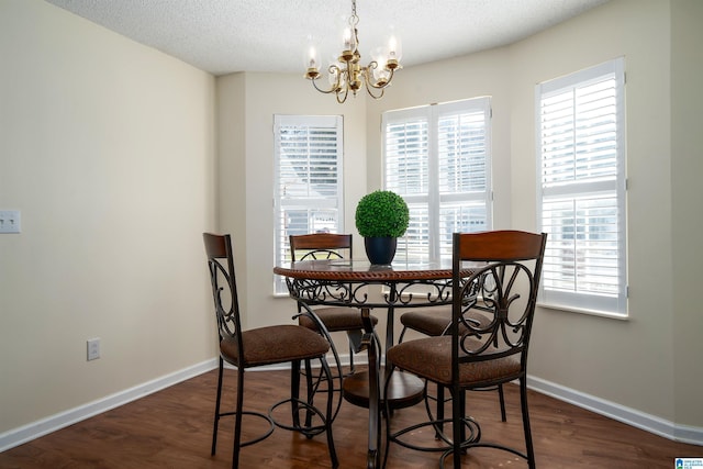 dining space featuring baseboards, dark wood-style flooring, and a textured ceiling