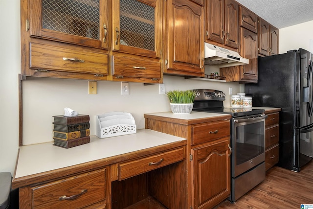 kitchen featuring dark wood-type flooring, under cabinet range hood, light countertops, stainless steel electric range, and a textured ceiling