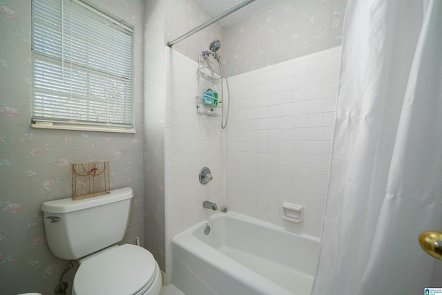 bathroom with toilet, shower / tub combo, and wallpapered walls