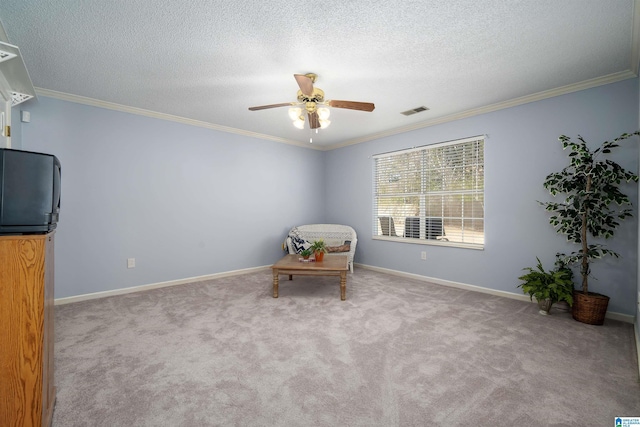 living area featuring visible vents, a textured ceiling, carpet floors, crown molding, and baseboards