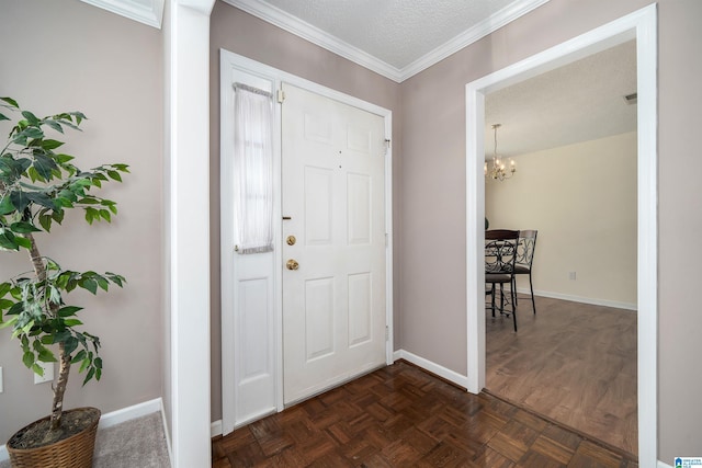 entryway with baseboards, a notable chandelier, ornamental molding, and a textured ceiling