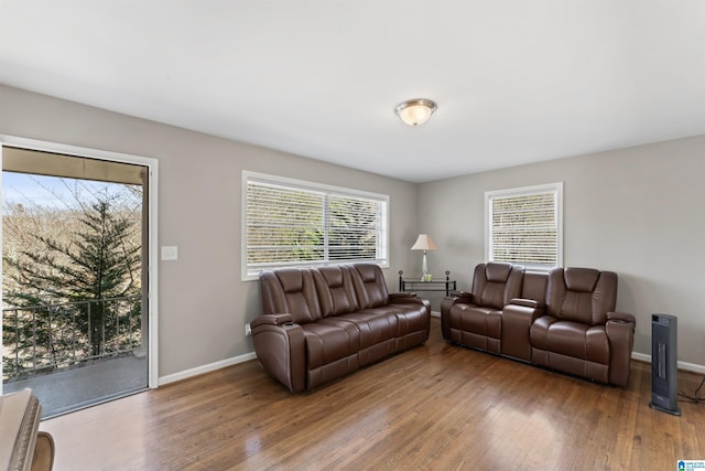 living room with plenty of natural light, wood finished floors, and baseboards