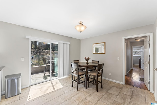 dining area featuring light tile patterned floors, visible vents, and baseboards