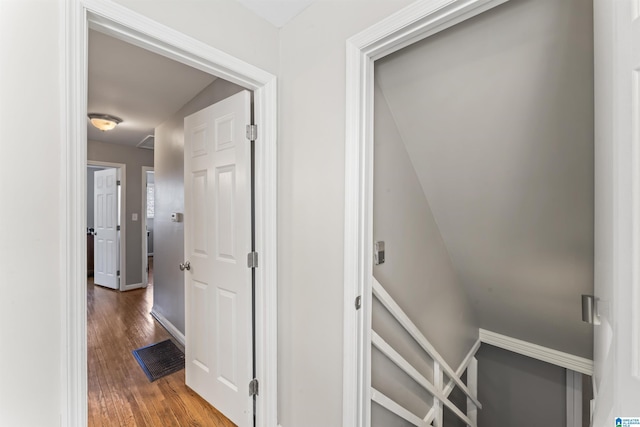 hallway featuring baseboards and wood finished floors