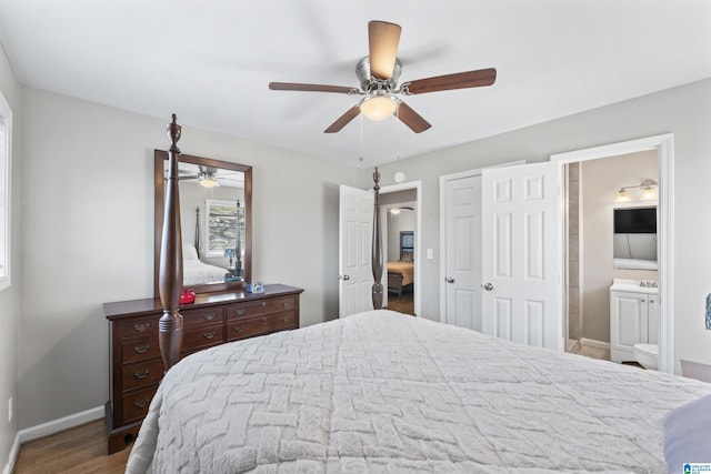 bedroom with wood finished floors, connected bathroom, a closet, baseboards, and ceiling fan