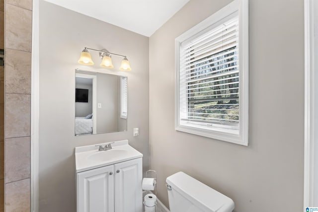 bathroom featuring connected bathroom, toilet, and vanity