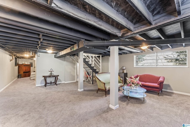 basement featuring baseboards, carpet floors, and stairs