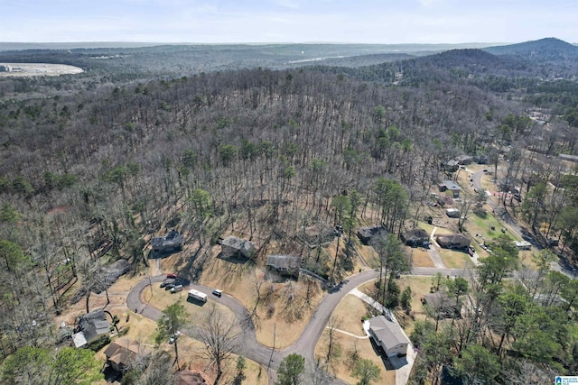 drone / aerial view with a forest view and a mountain view