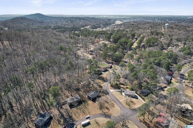 drone / aerial view featuring a wooded view