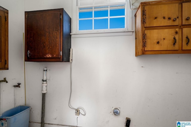 washroom with cabinet space and hookup for a washing machine