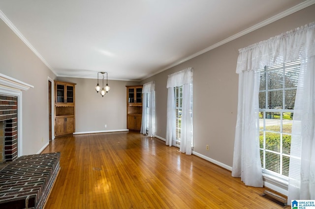 unfurnished living room with baseboards, wood-type flooring, and a chandelier