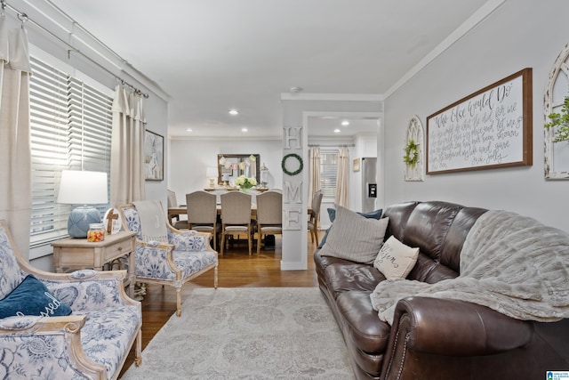 living area featuring recessed lighting, wood finished floors, and ornamental molding