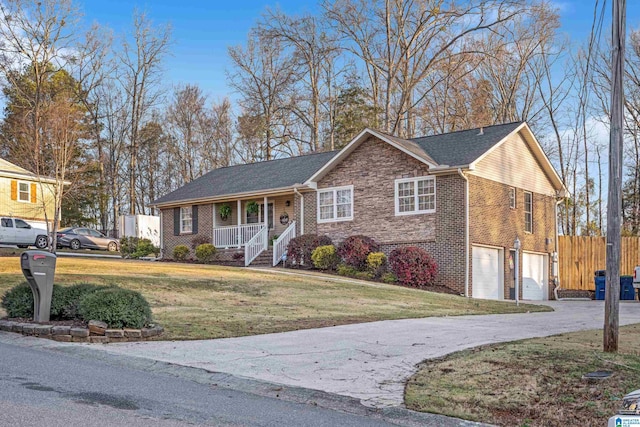 ranch-style home with fence, covered porch, an attached garage, a front yard, and brick siding