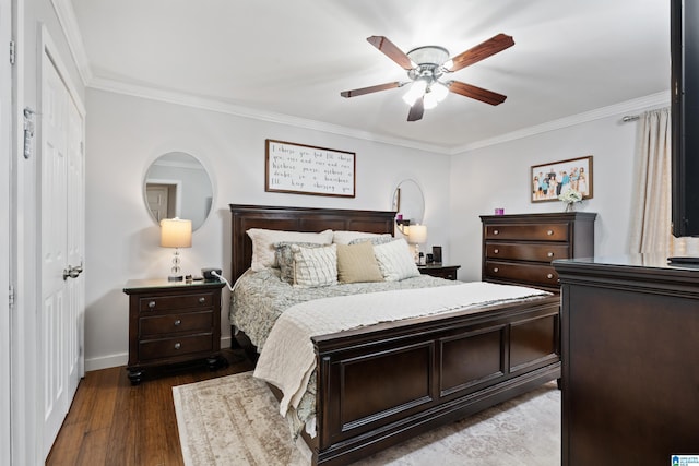 bedroom with crown molding, wood finished floors, baseboards, and ceiling fan