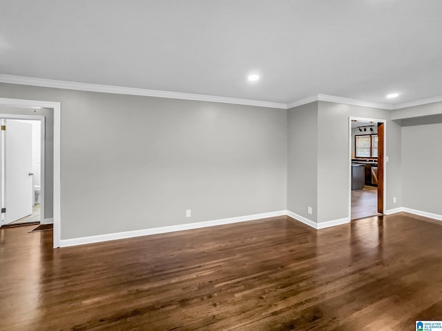 empty room with recessed lighting, baseboards, dark wood-style flooring, and crown molding