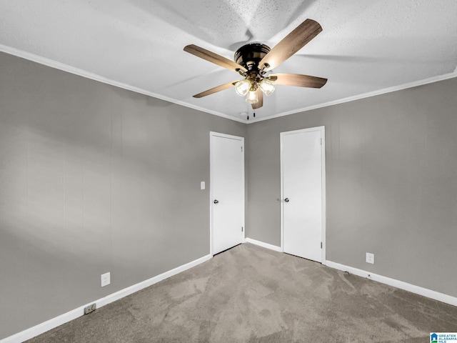 unfurnished bedroom with baseboards, carpet floors, ceiling fan, ornamental molding, and a textured ceiling