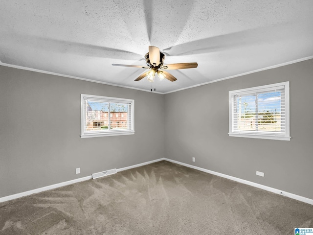 carpeted empty room with crown molding, plenty of natural light, and baseboards