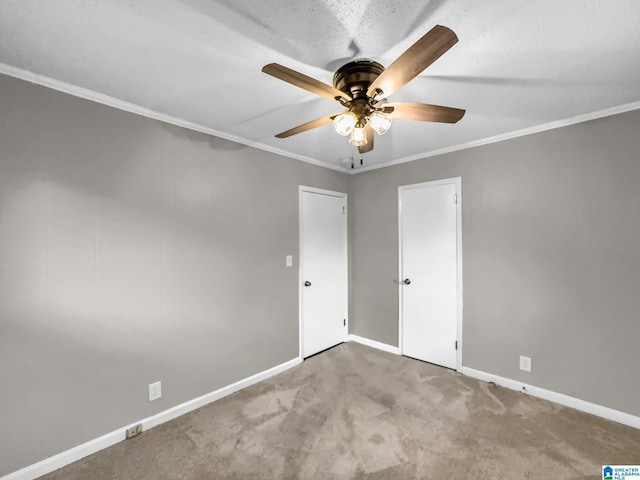 unfurnished bedroom featuring baseboards, carpet floors, ornamental molding, and a ceiling fan