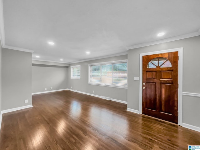 entryway featuring dark wood-style floors, visible vents, baseboards, and ornamental molding