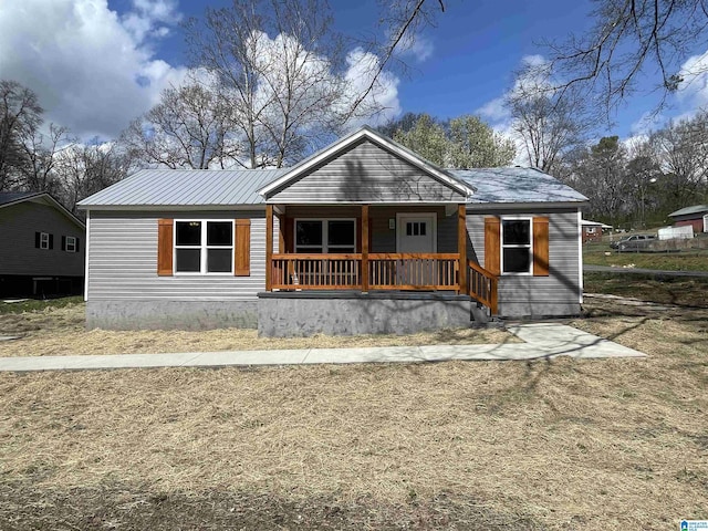 view of front of home featuring metal roof and covered porch