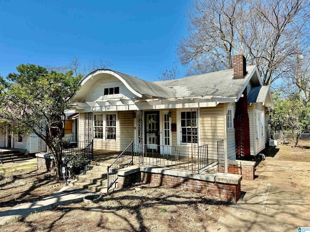 view of front of property featuring a porch and a chimney