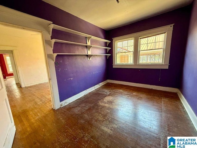 interior space featuring baseboards and wood finished floors