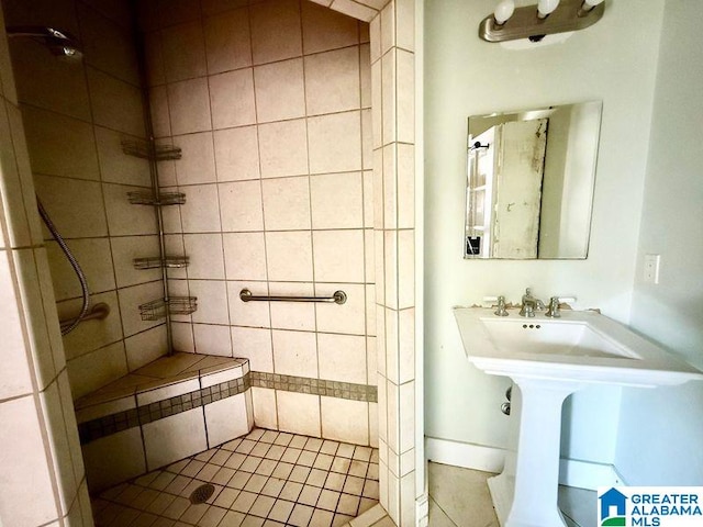 bathroom featuring a sink and a tile shower