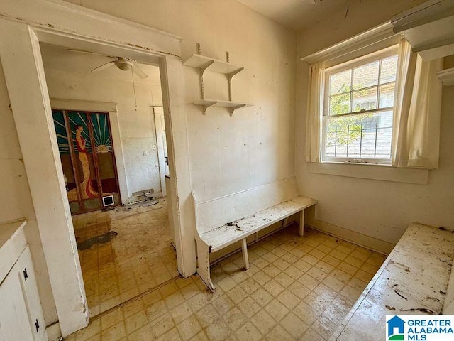 interior space with tile patterned floors and ceiling fan