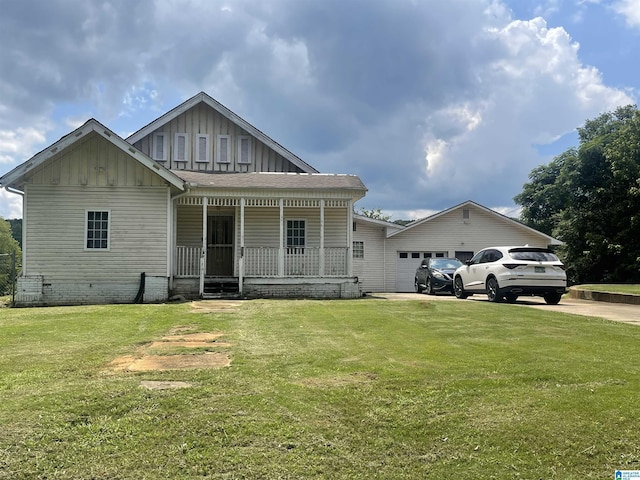 view of front of house with driveway, a porch, board and batten siding, a front yard, and a garage