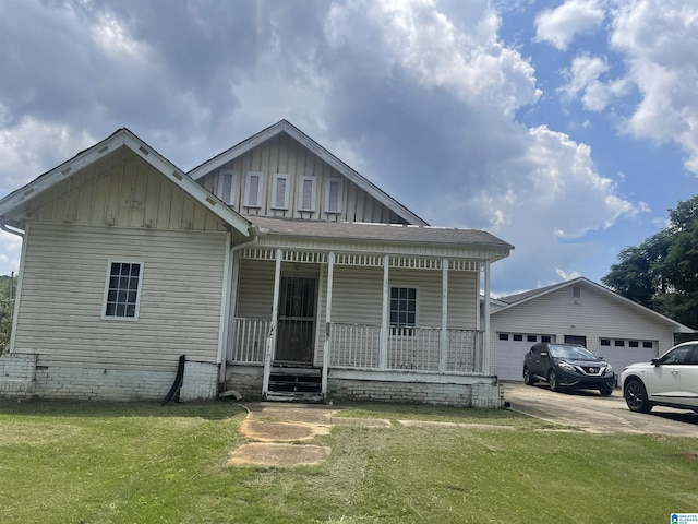 view of front of home with a porch, board and batten siding, a front yard, a shingled roof, and a garage