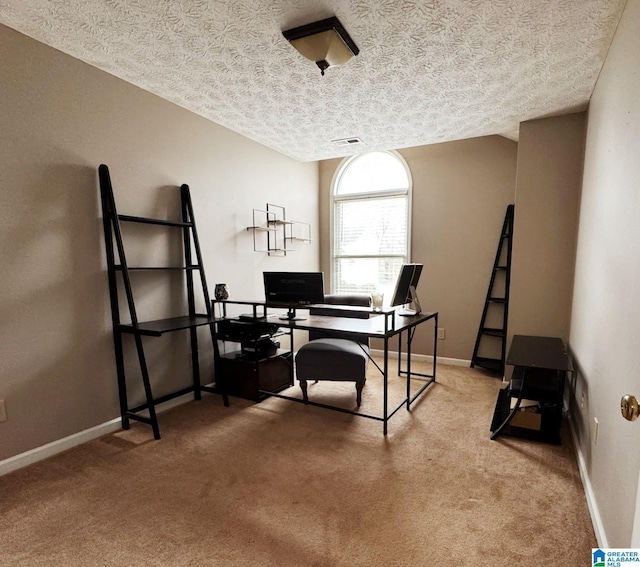 office space featuring visible vents, carpet floors, a textured ceiling, and baseboards