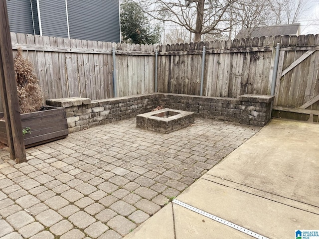 view of patio / terrace featuring a fenced backyard and a fire pit