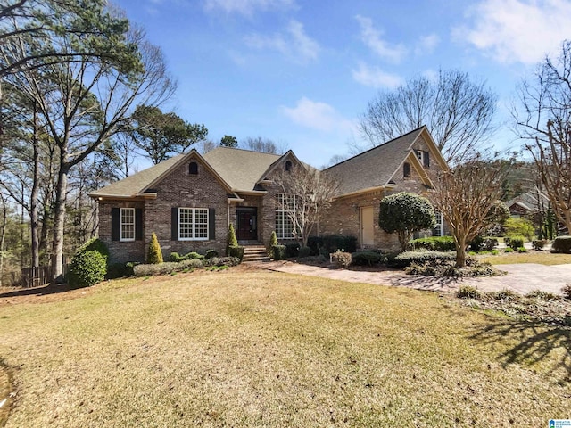 view of front facade featuring brick siding and a front lawn