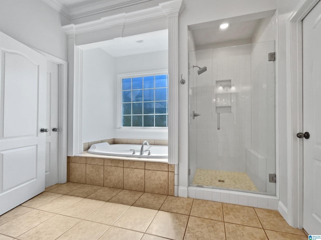 bathroom with tile patterned flooring, a stall shower, a bath, and ornamental molding