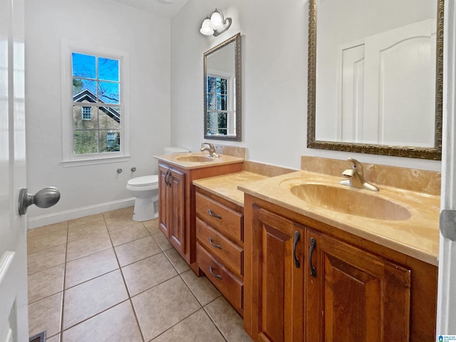 bathroom with tile patterned floors, toilet, vanity, and baseboards