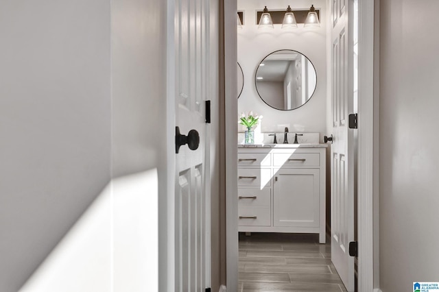 bathroom with wood tiled floor and vanity