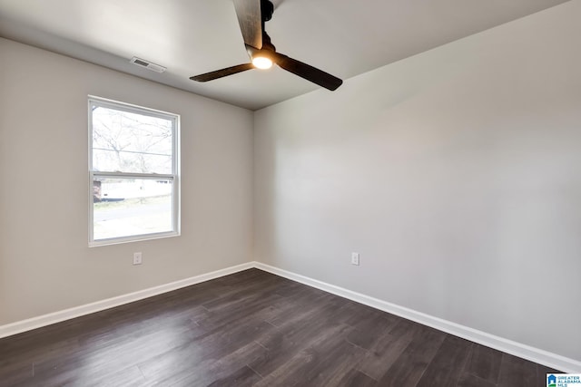 empty room featuring dark wood-style floors, baseboards, visible vents, and ceiling fan