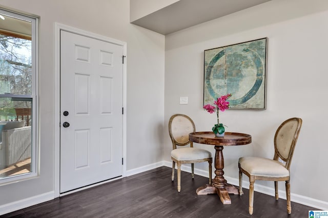 foyer featuring dark wood-style floors and baseboards