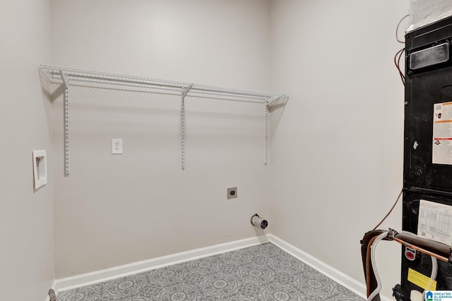 clothes washing area featuring laundry area, heating unit, baseboards, and hookup for an electric dryer