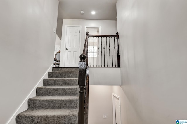 staircase featuring baseboards