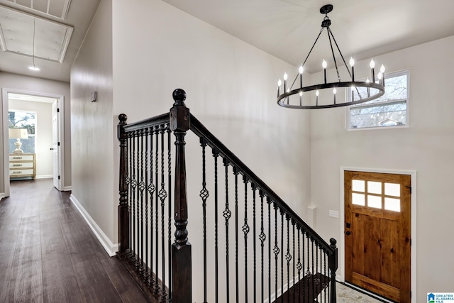 foyer entrance featuring baseboards and wood finished floors