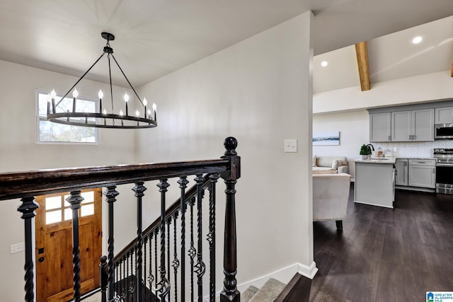 stairs featuring beamed ceiling, wood finished floors, recessed lighting, baseboards, and a chandelier