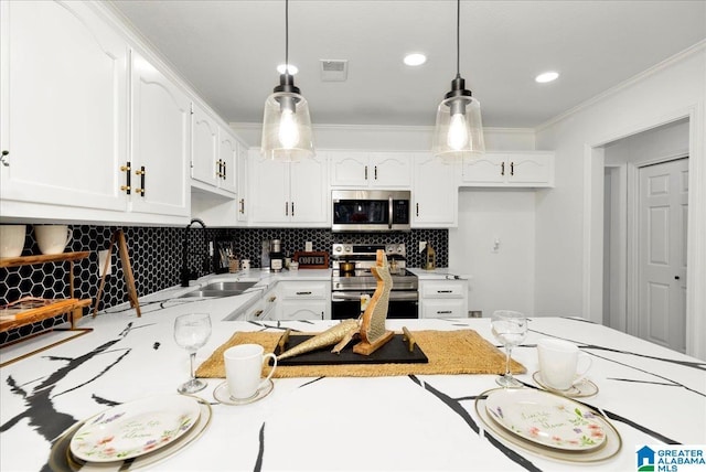 kitchen with a sink, tasteful backsplash, stainless steel appliances, crown molding, and hanging light fixtures