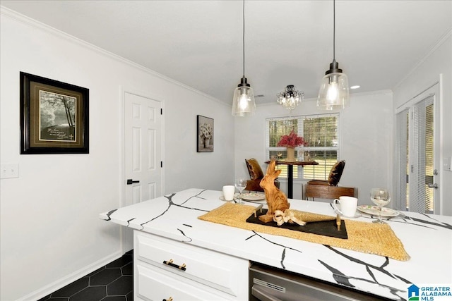 kitchen featuring pendant lighting, light countertops, ornamental molding, white cabinets, and stainless steel dishwasher