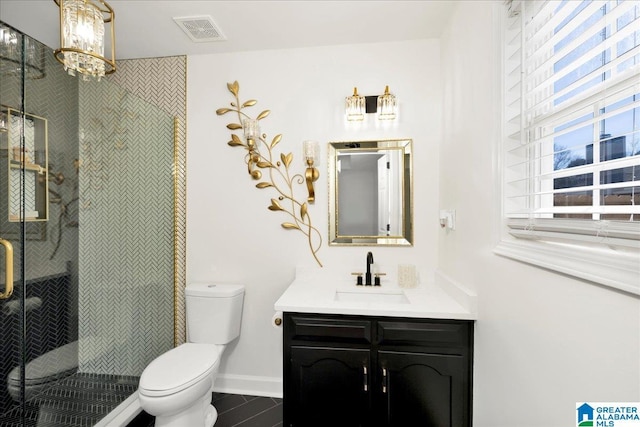 full bath with visible vents, toilet, a shower stall, baseboards, and vanity