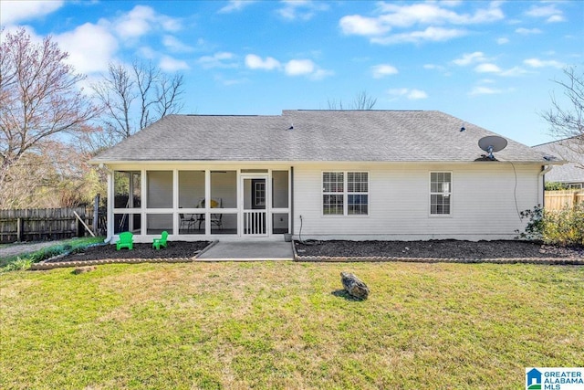 back of house with a yard, fence, a sunroom, and a shingled roof